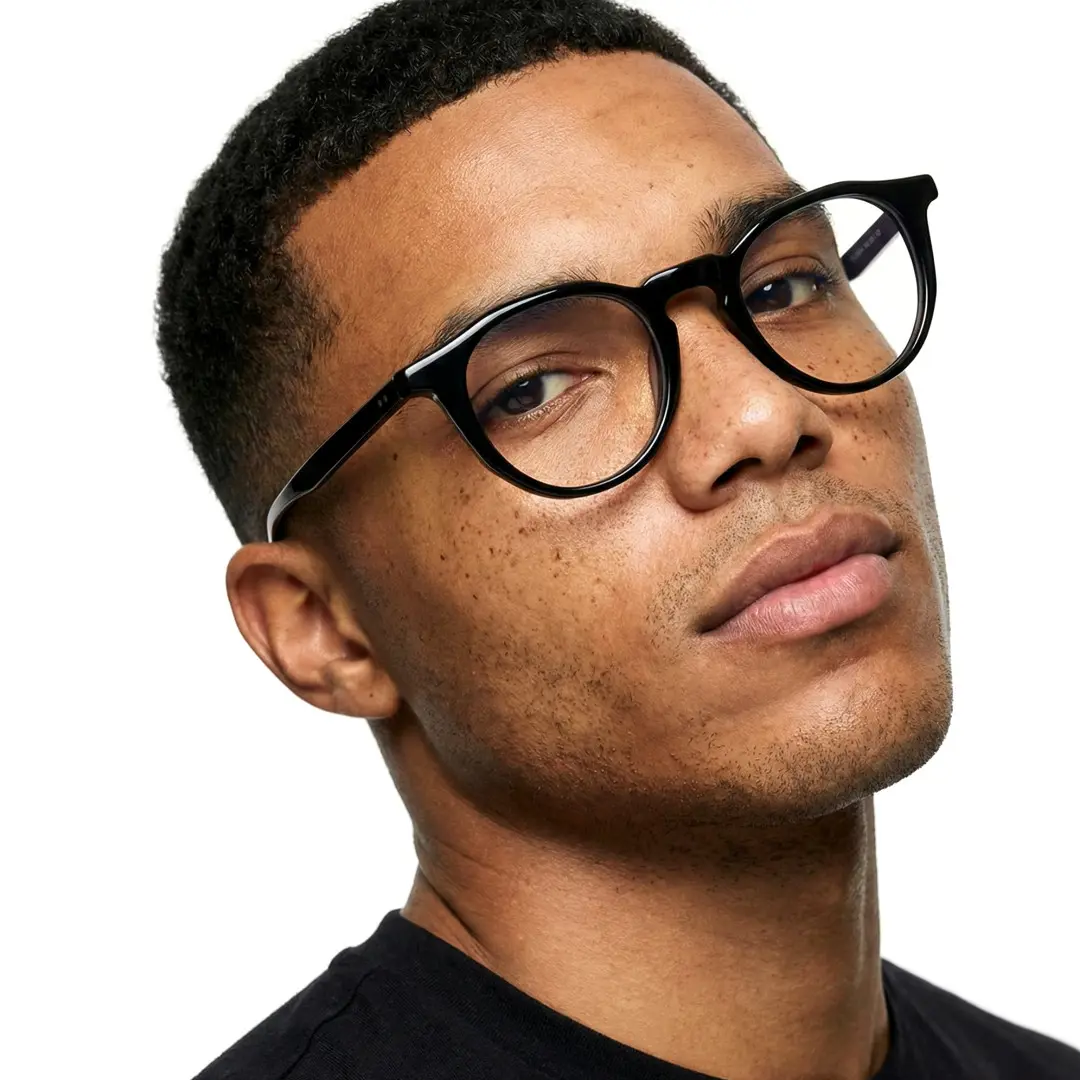 Slightly angled view of male wearing black geometric eyeglasses, neutral expression, GA0262403