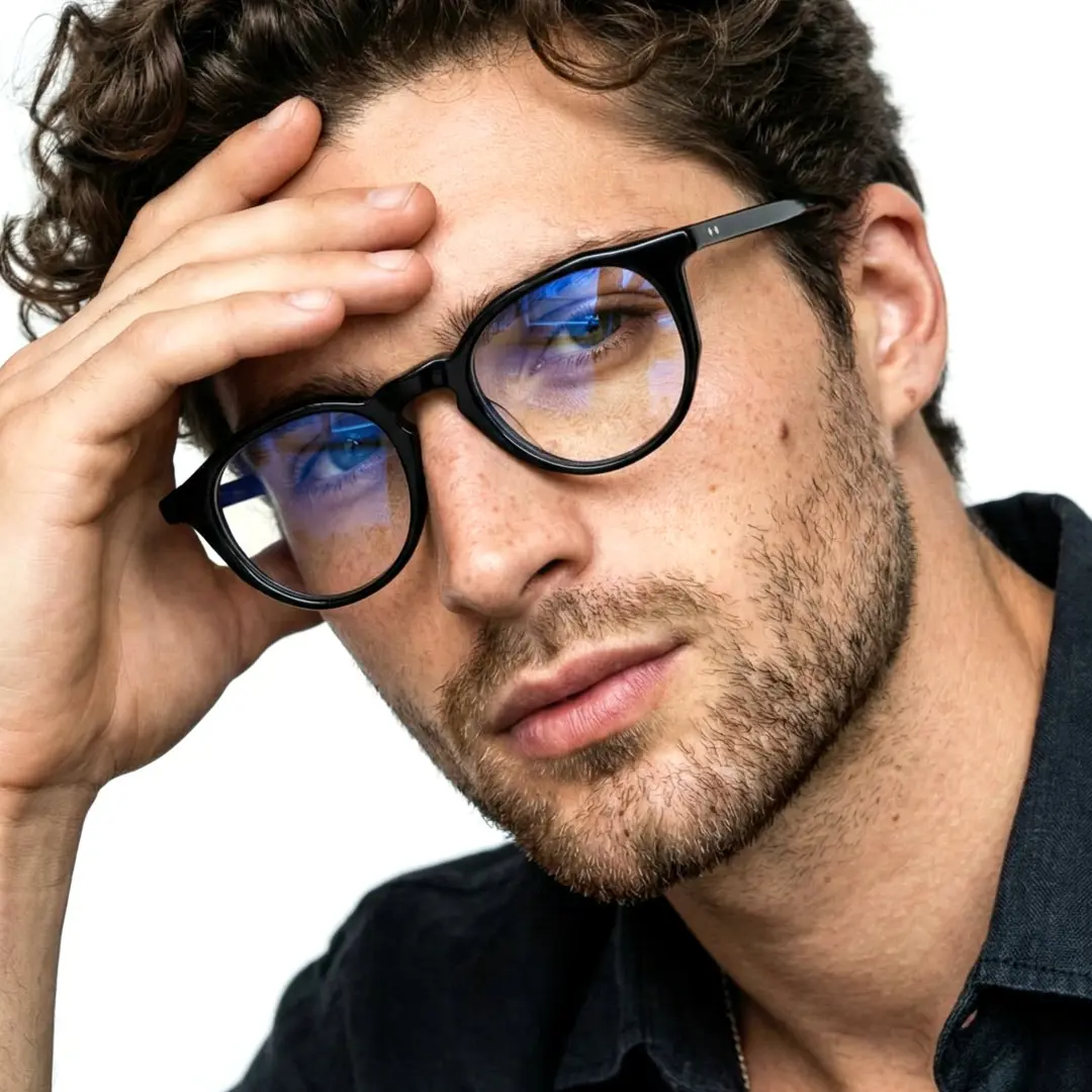 Slightly angled view of male wearing vintage black geometric eyeglasses, hand resting on forehead, neutral expression, GA0262403