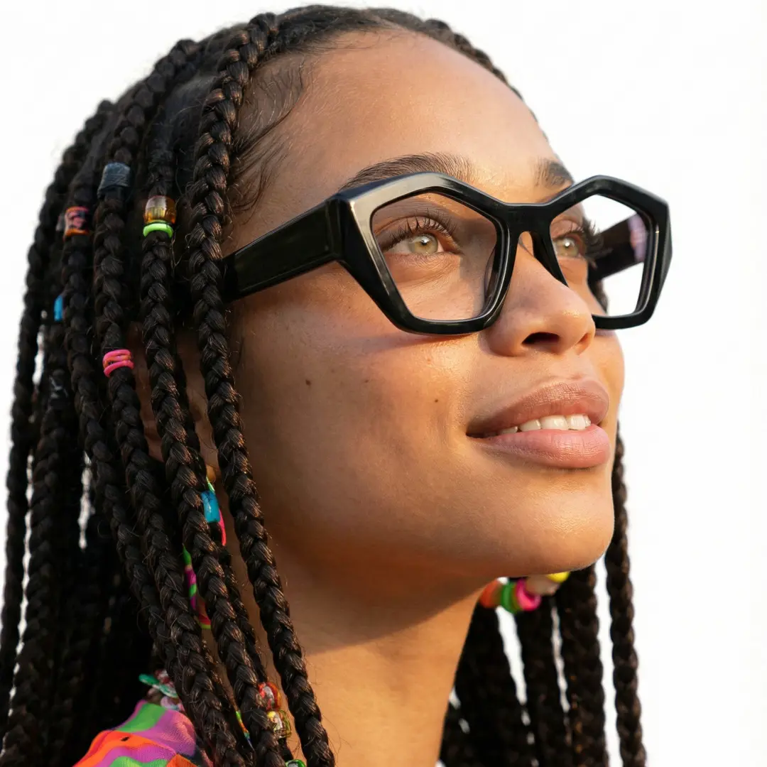Profile view of female wearing black geometric eyeglasses, natural smile, GA0302411