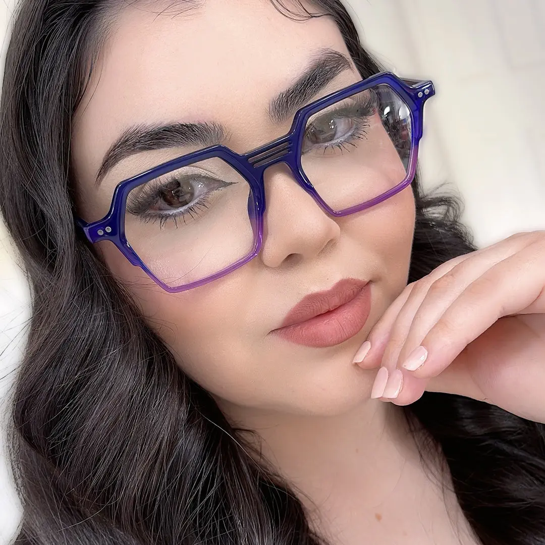 Close-up view of female wearing purple geometric eyeglasses, hand touching chin, neutral expression, GA0412503