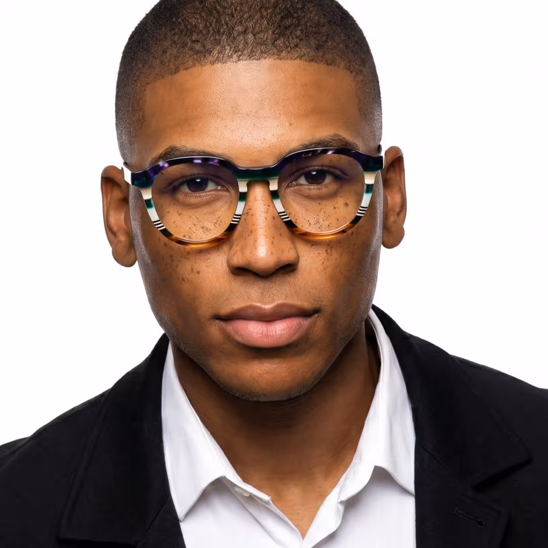 Male wearing colorful multicolor geometric acetate eyeglasses, maintaining a neutral expression while looking at camera. SPU: GA0412605