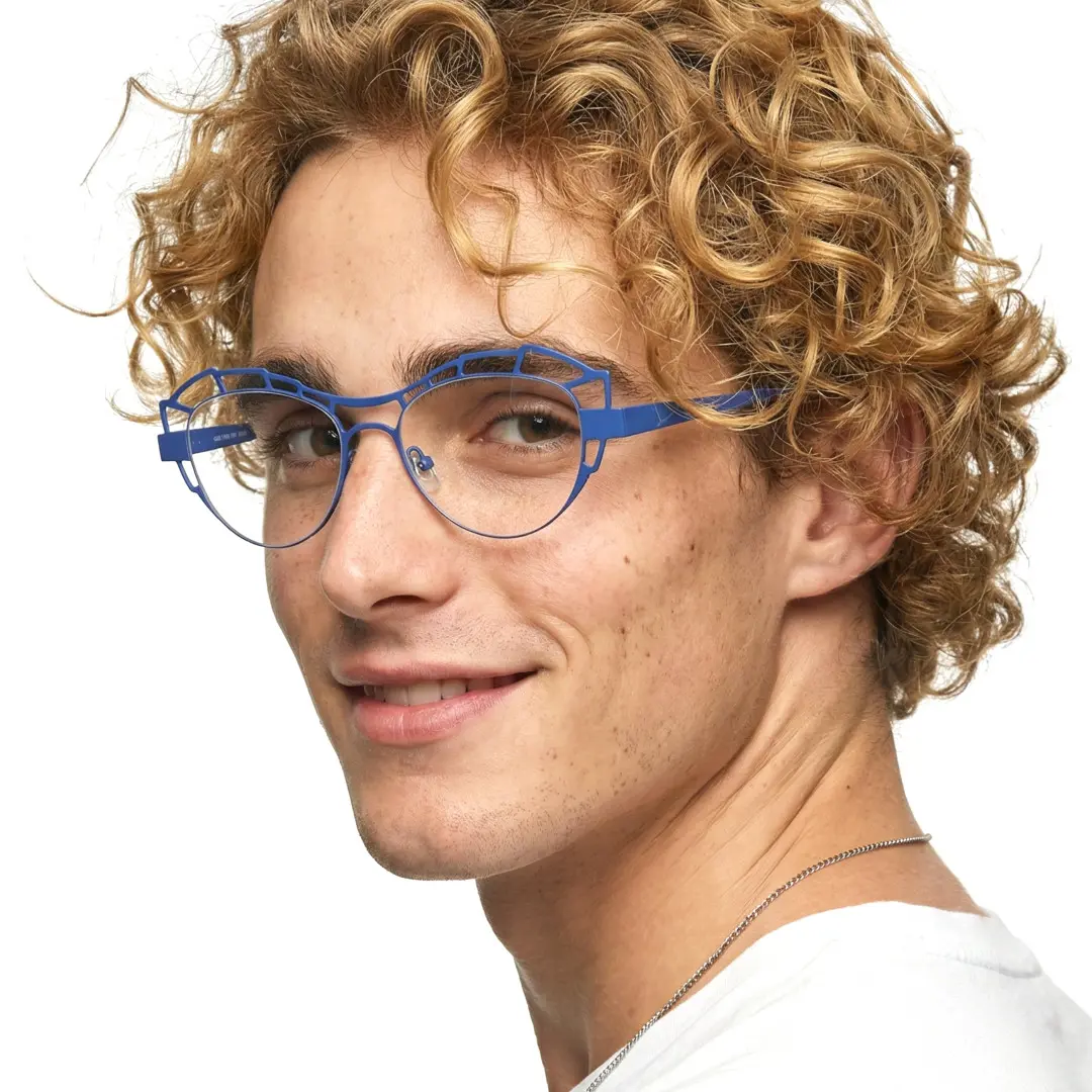 Over-the-shoulder view of male wearing blue geometric eyeglasses, natural smile, GM0062212