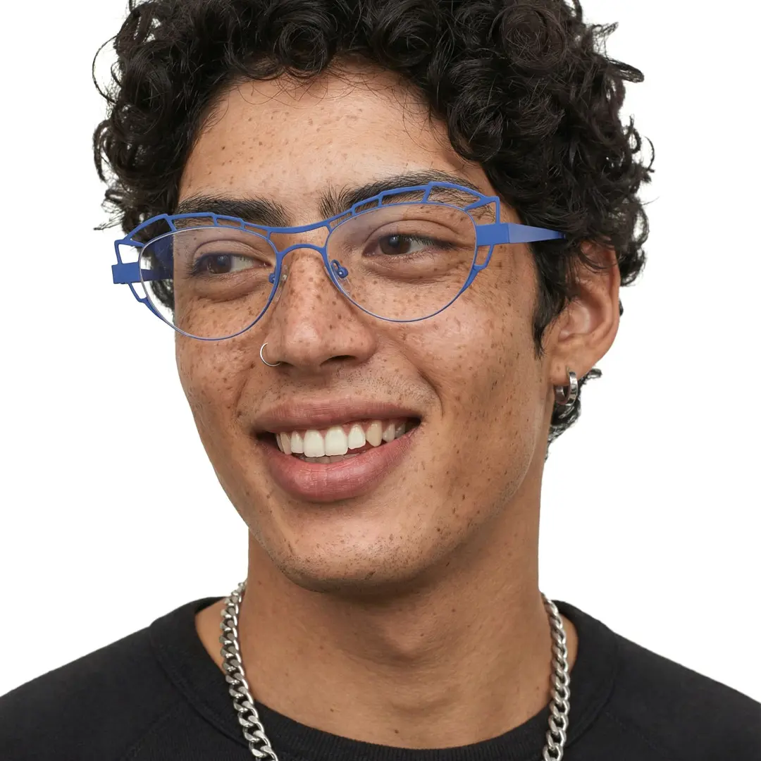 Three-quarter view of male wearing blue geometric eyeglasses, smiling, GM0062212