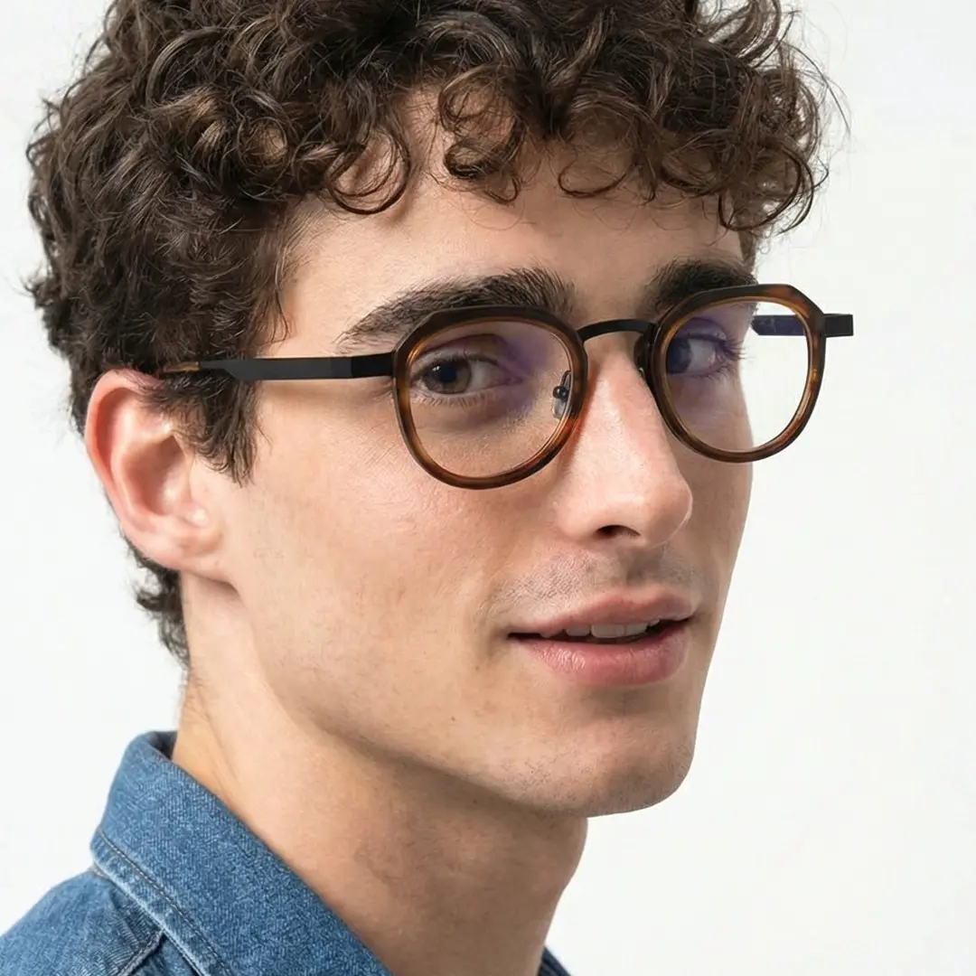 Over-the-shoulder view of male wearing vintage brown tortoise geometric eyeglasses, smiling, GM0062304
