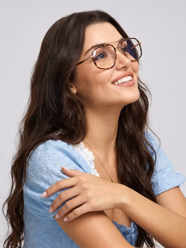 Female model wearing everyday tortoise geometric metal eyeglasses in a clean studio setting. SPU: GM0072605