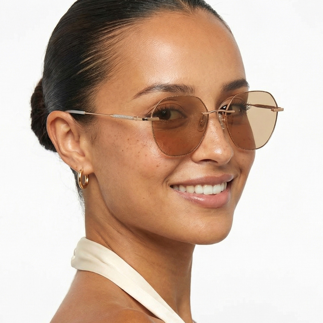Over-the-shoulder view of female wearing brown geometric sunglasses, smiling, GM0132410