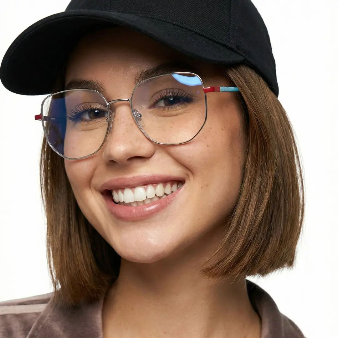 Front view of female wearing silver geometric eyeglasses, smiling, GM0502302