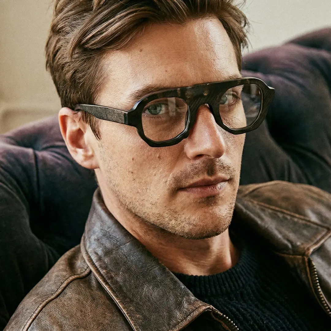 Profile view of male wearing gray geometric natural ox horn handcrafted eyeglasses, calm expression, GO0242511