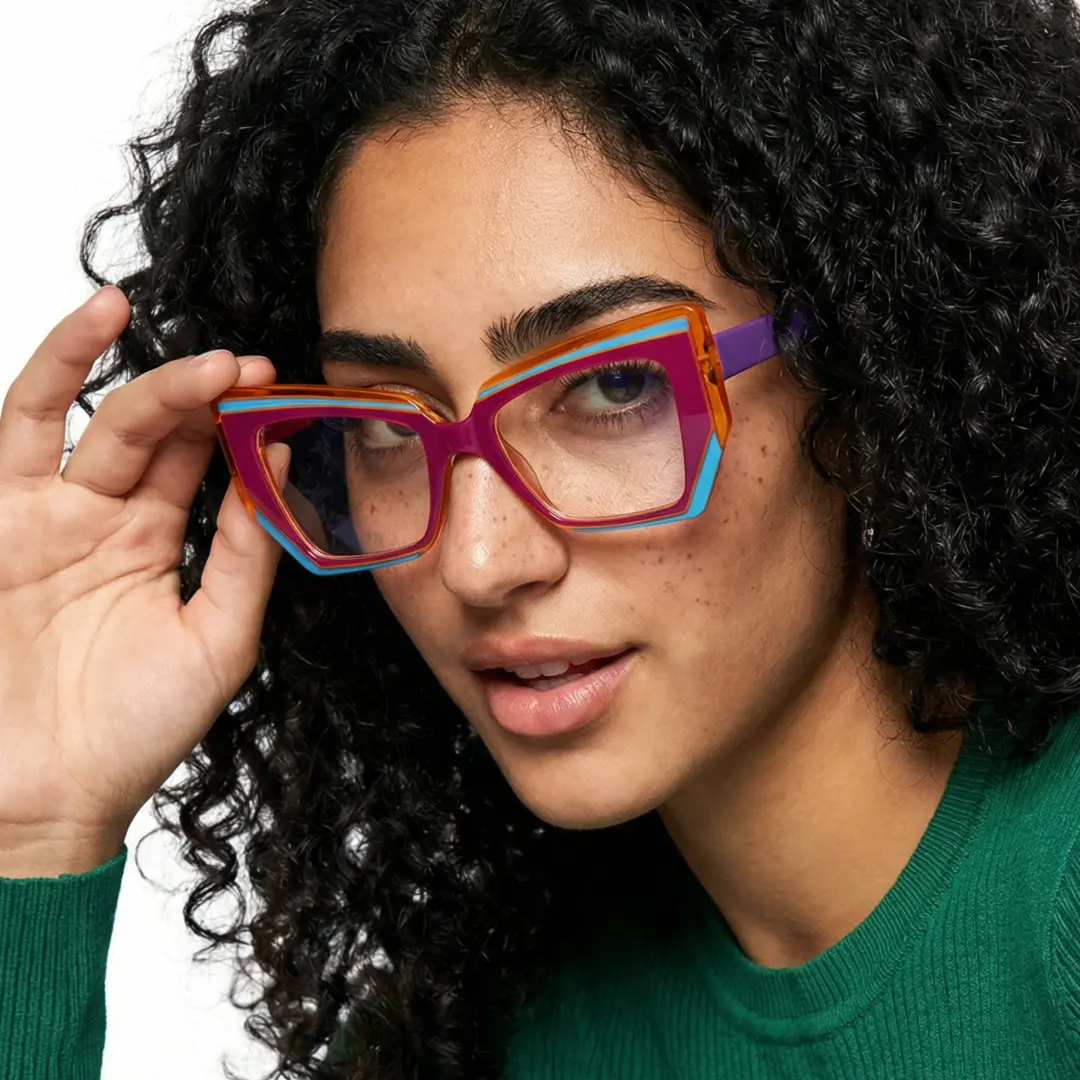 Face close-up view of female wearing pink cat eye eyeglasses, holding glasses, neutral expression, GP0022403