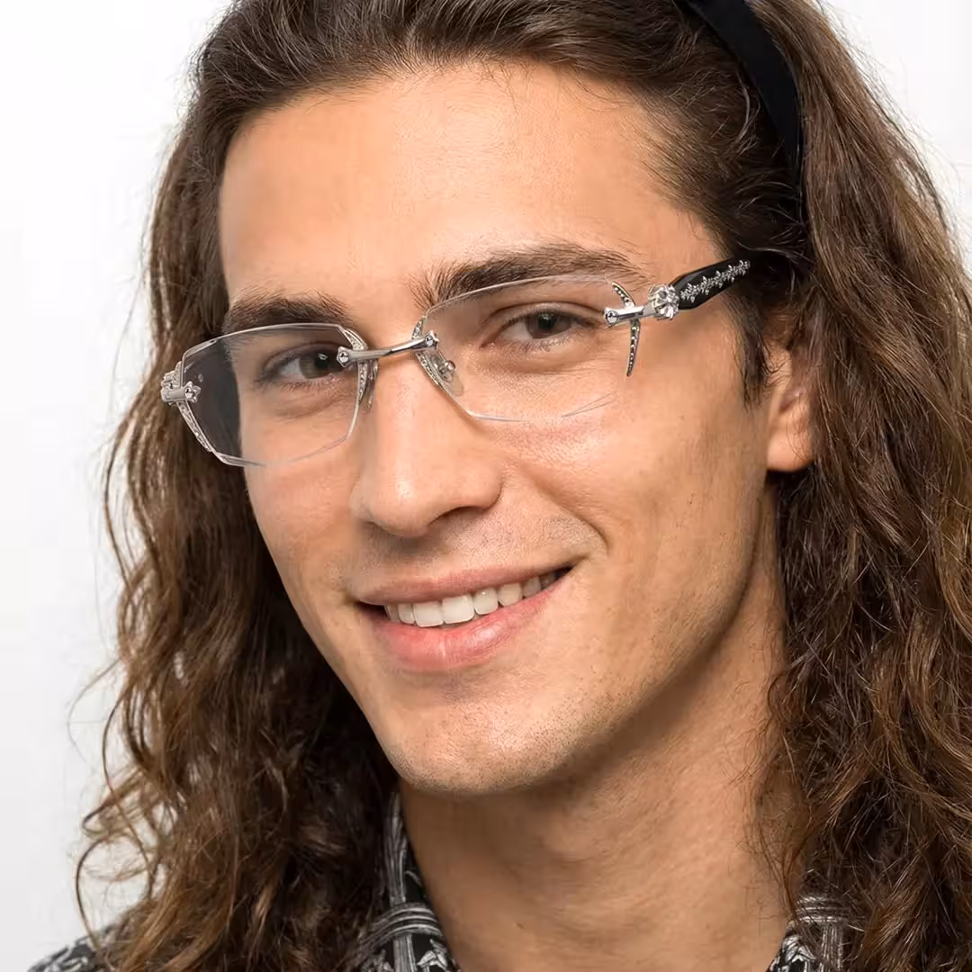 Close-up view of male wearing silver geometric eyeglasses, natural smile, GP0322512