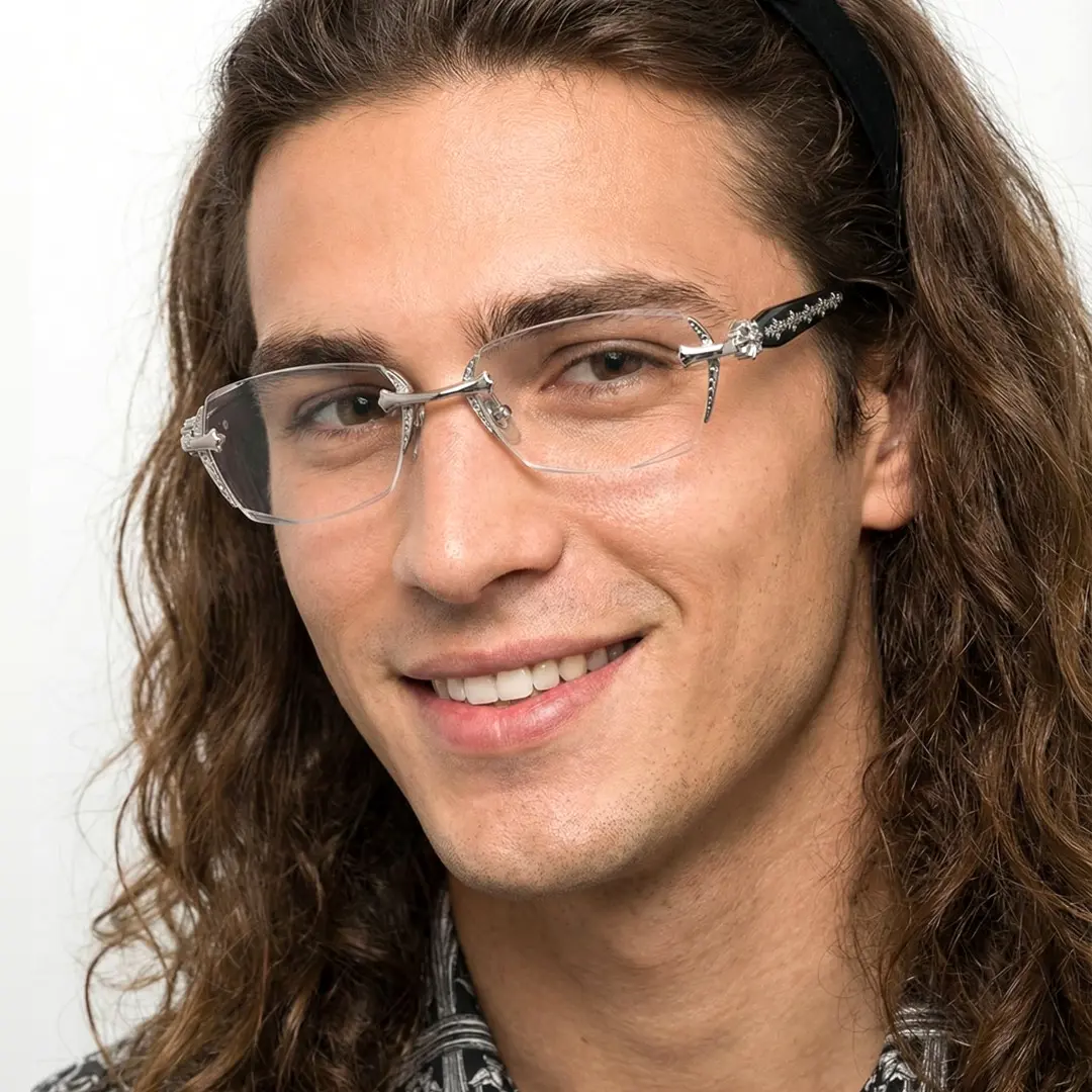 Face close-up view of male wearing silver geometric eyeglasses, smiling, GP0322512