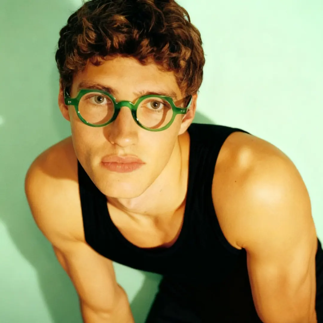 Front view of male wearing green geometric eyeglasses, neutral expression, GP0342411