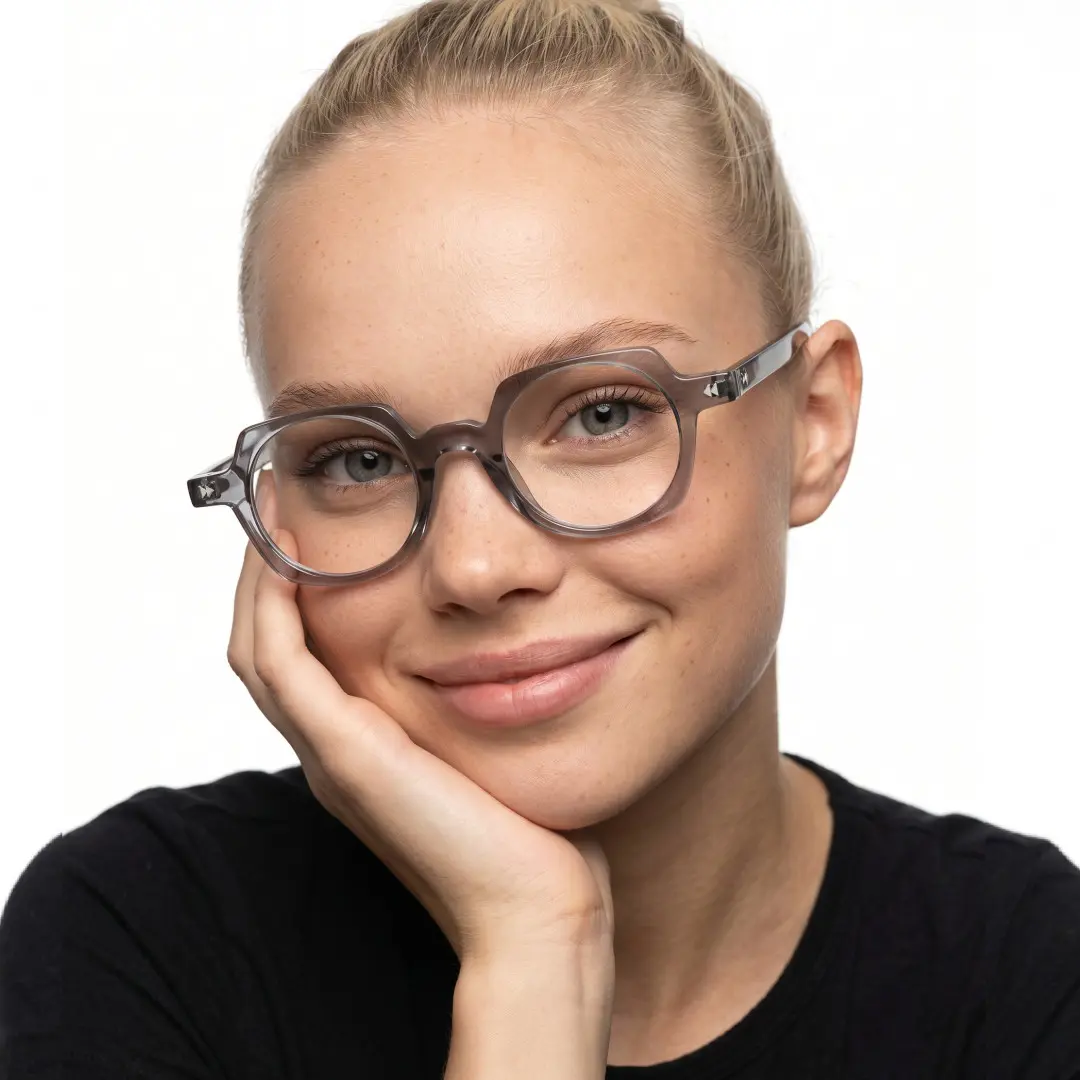 Front view of female wearing vintage grey geometric eyeglasses, hand near face, friendly smile, GP0342411