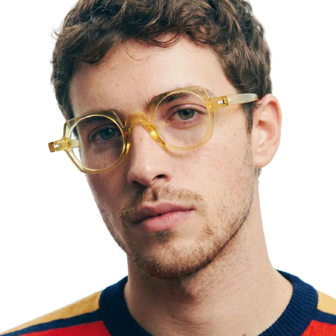 Front view of male wearing vintage yellow geometric eyeglasses, natural expression, GP0342411