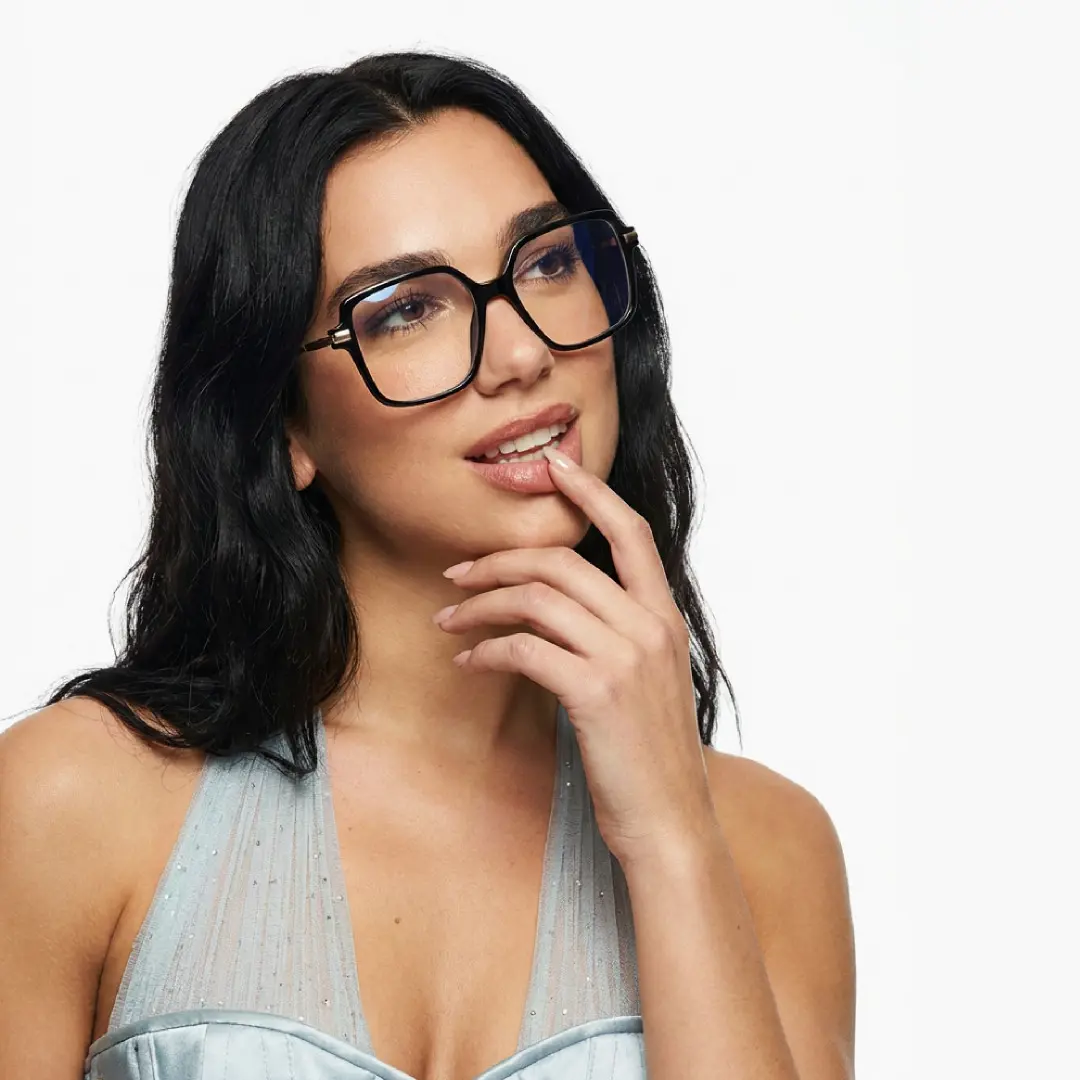 Looking away view of female wearing black geometric eyeglasses, smiling, GR0032510