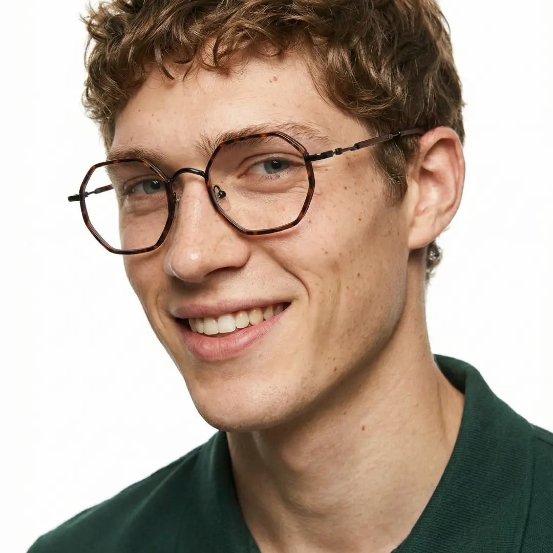 Profile view of male wearing tortoise geometric eyeglasses, smiling, GR0102308