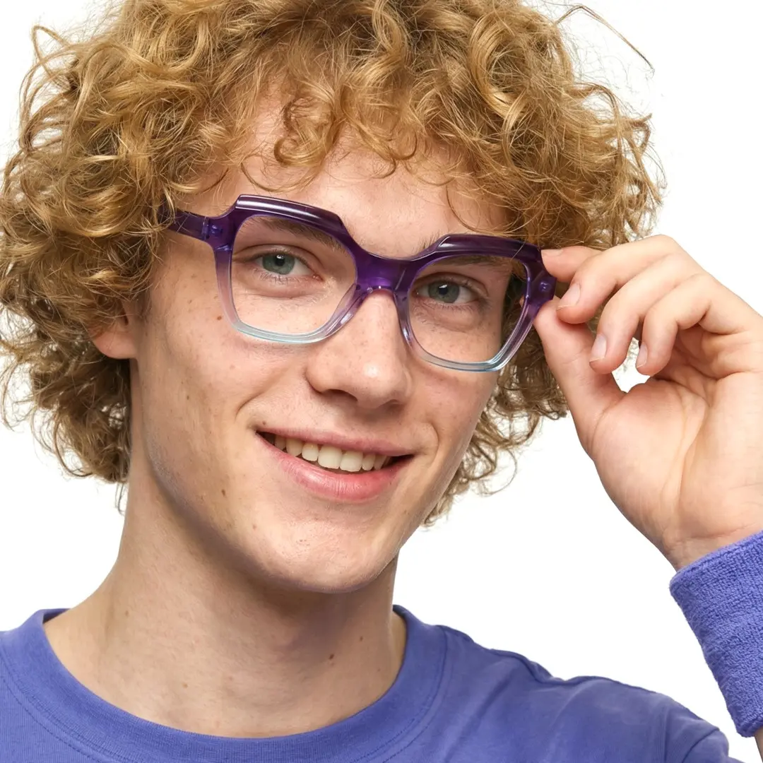 Portrait view of male wearing light purple geometric eyeglasses, holding glasses, natural smile, GR0402302