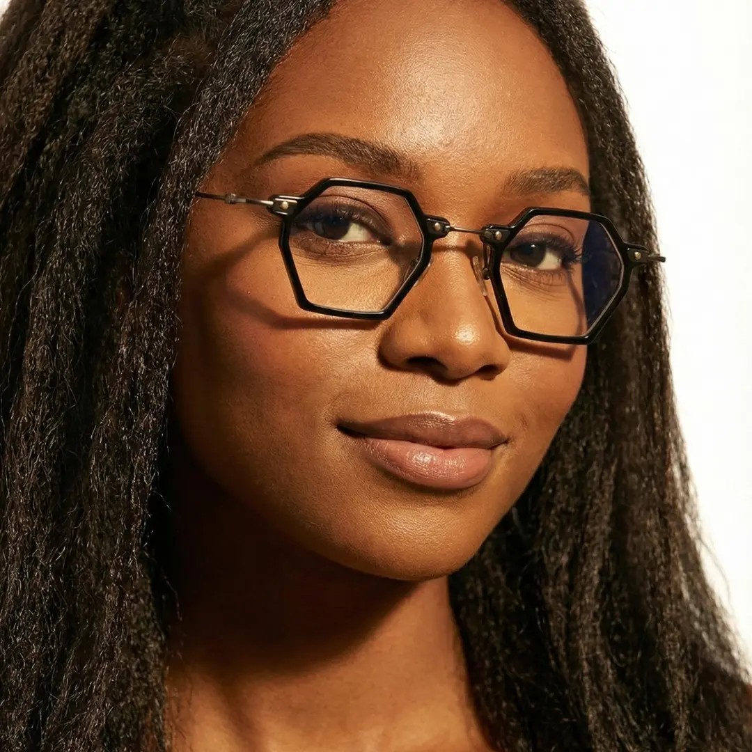 Slightly angled view of female wearing black geometric eyeglasses, relaxed expression, GT0032306