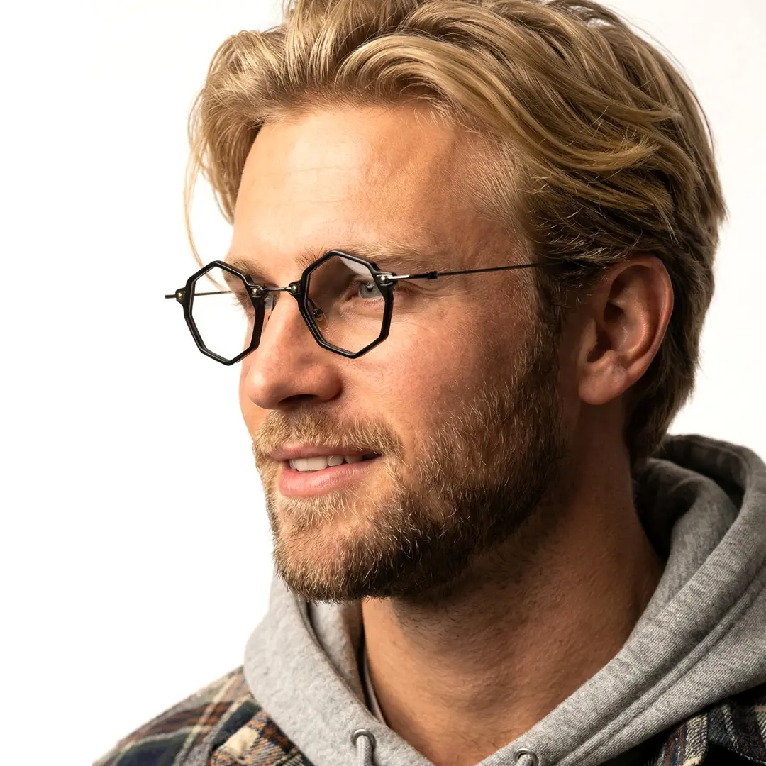 Looking away view of male wearing black geometric eyeglasses, natural expression, GT0332411