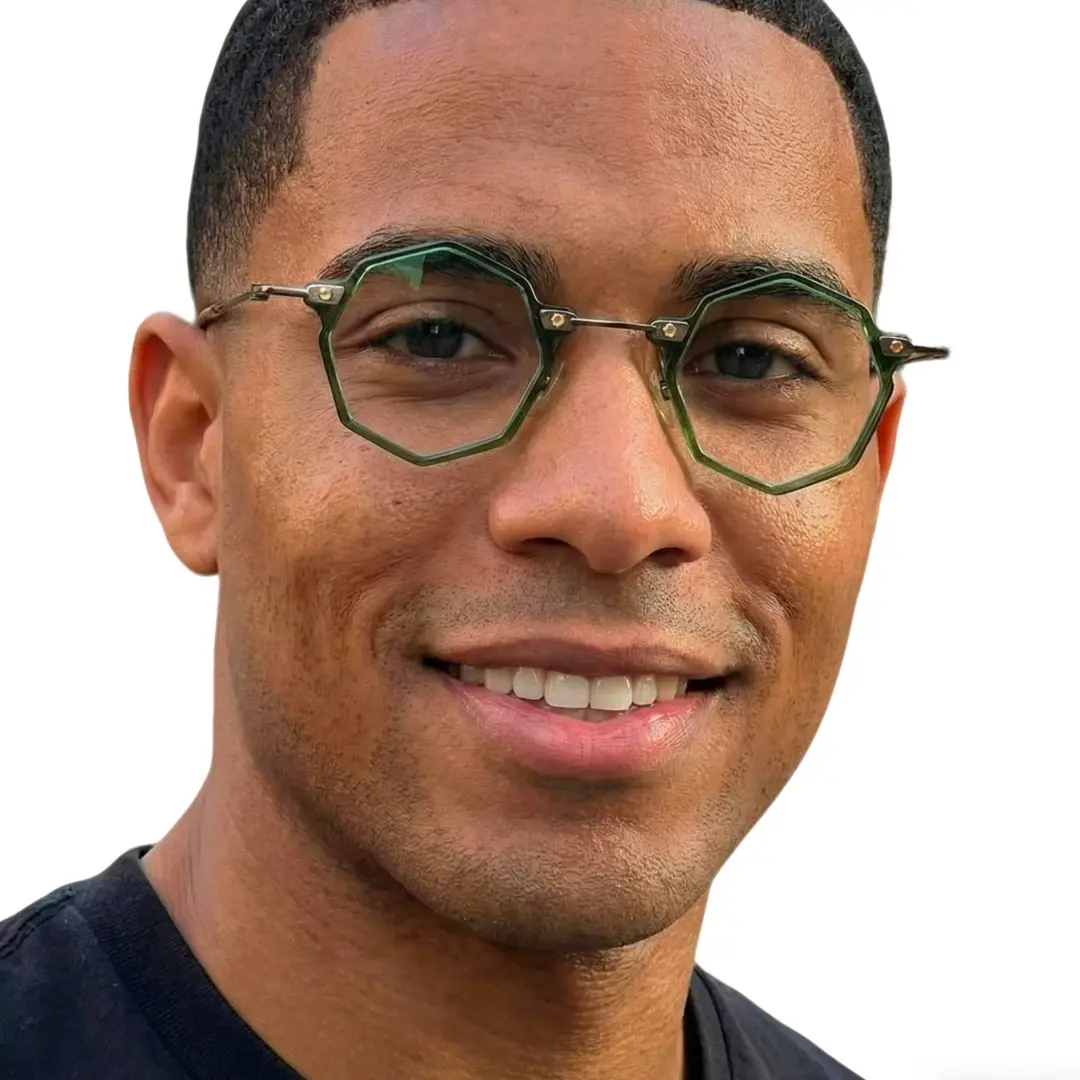 Face close-up view of male wearing green geometric eyeglasses, friendly smile, GT0332411