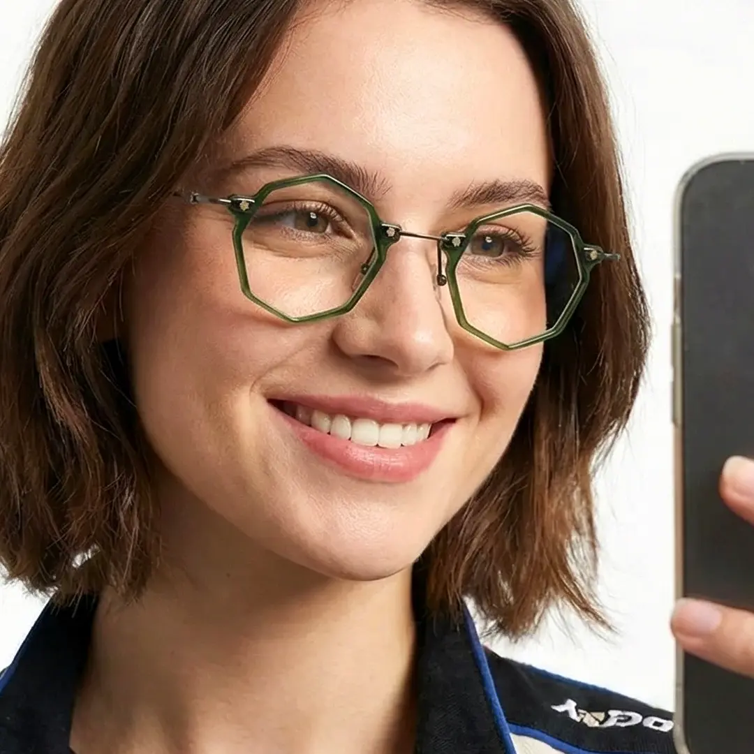 Looking away view of female wearing steampunk green geometric eyeglasses, taking a selfie, smiling, GT0332411