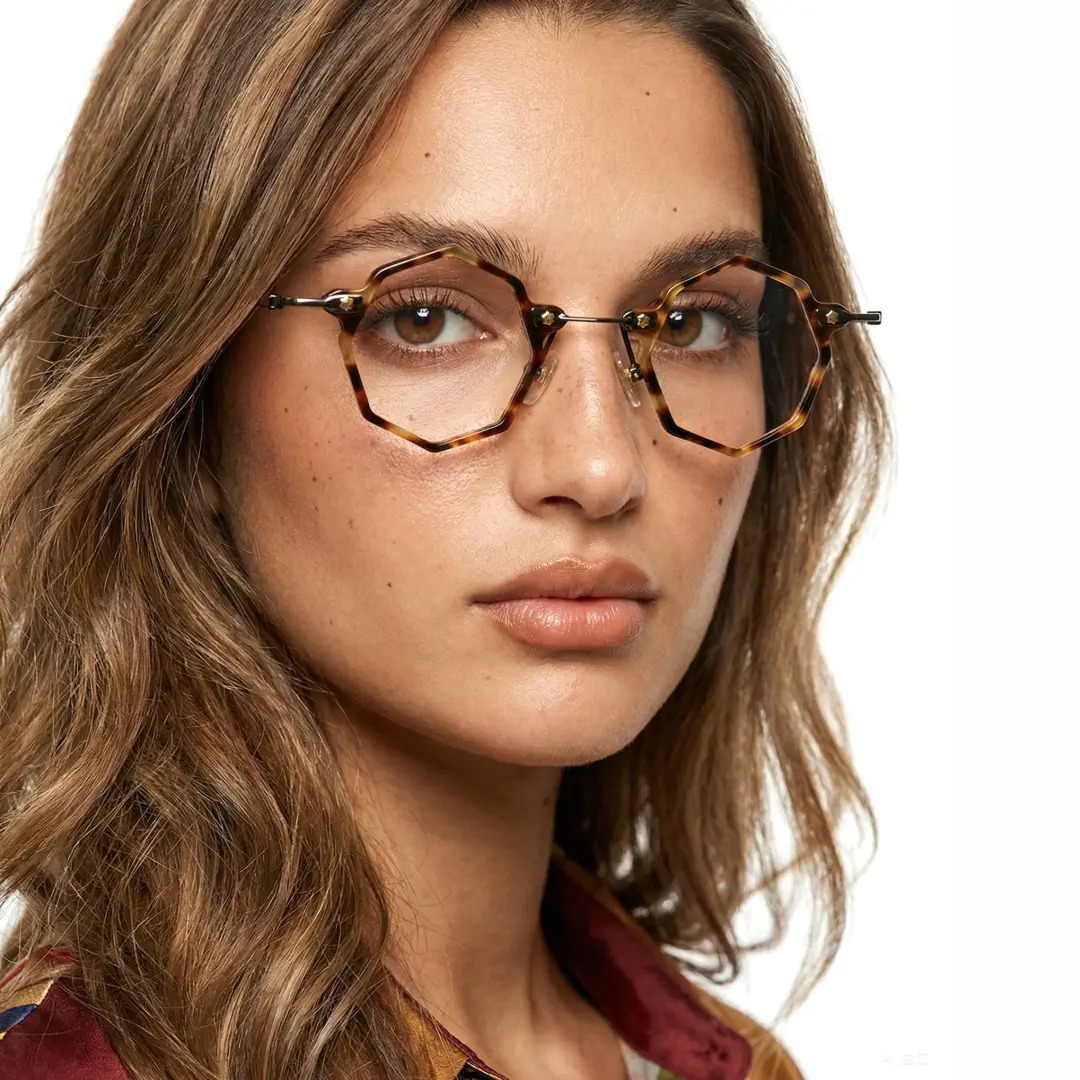 Face close-up view of female wearing steampunk tortoise geometric eyeglasses, neutral expression, GT0332411