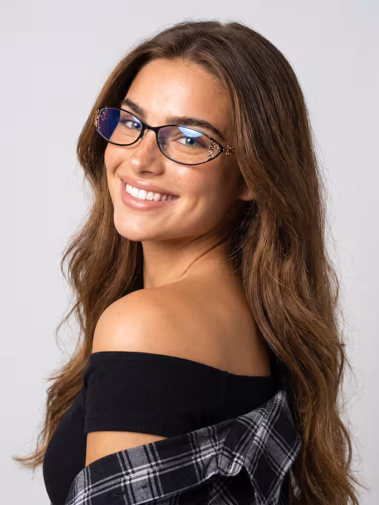 Female model wearing y2k black oval metal eyeglasses in a clean studio setting. SPU: OM0162604