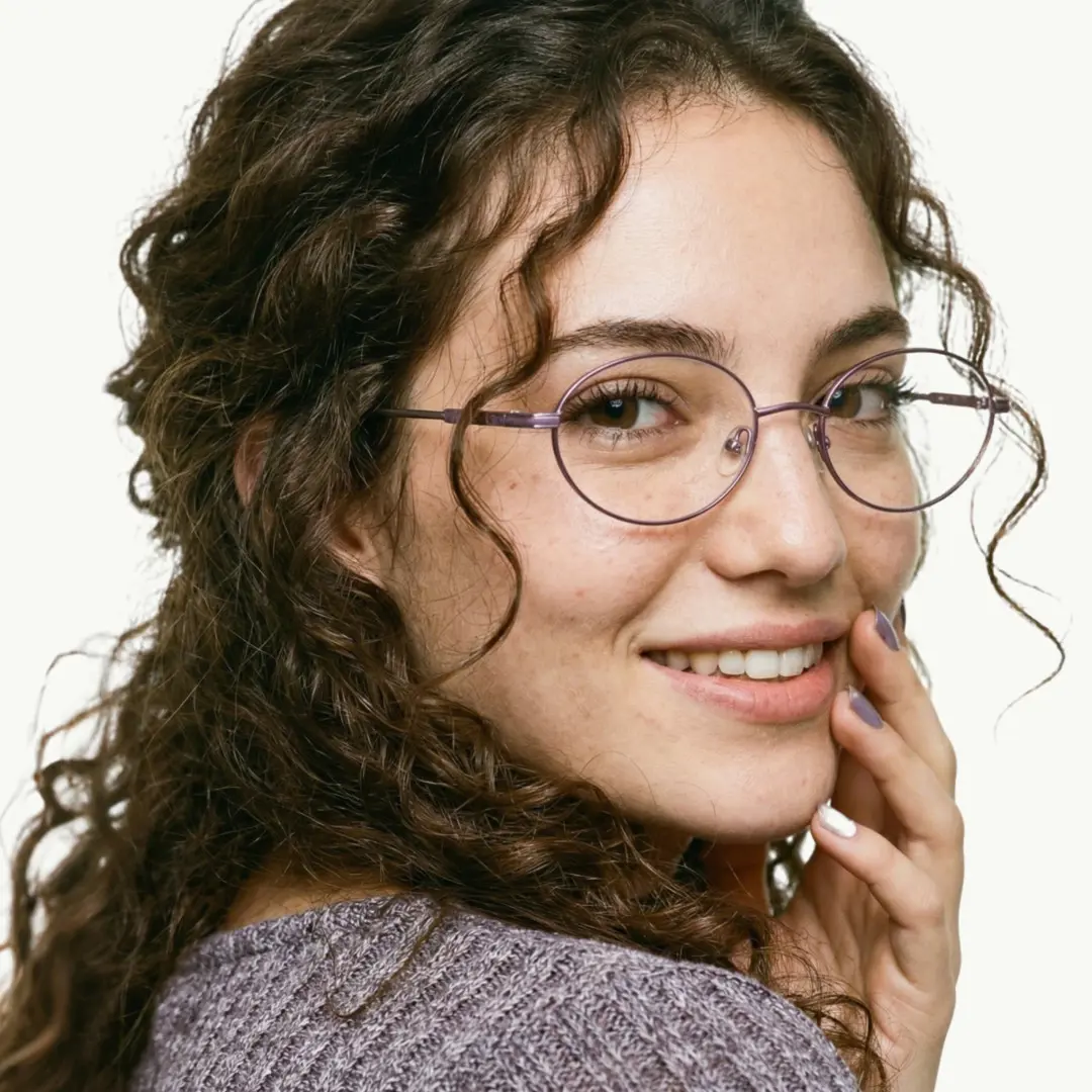 Over-the-shoulder view of female wearing y2k light purple oval eyeglasses, natural smile, OM0172410