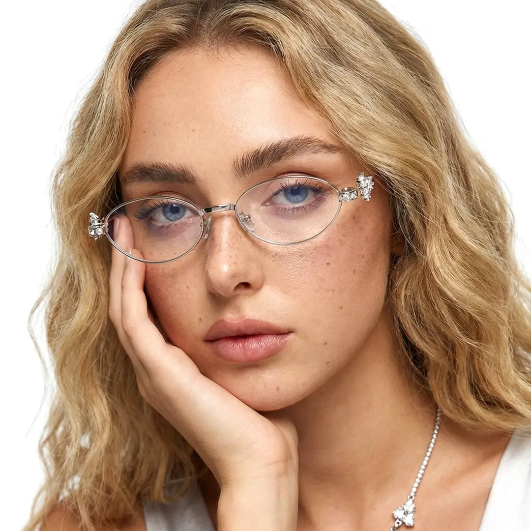 Front view of female wearing y2k silver oval eyeglasses, resting chin on hand, neutral expression, OM0252601