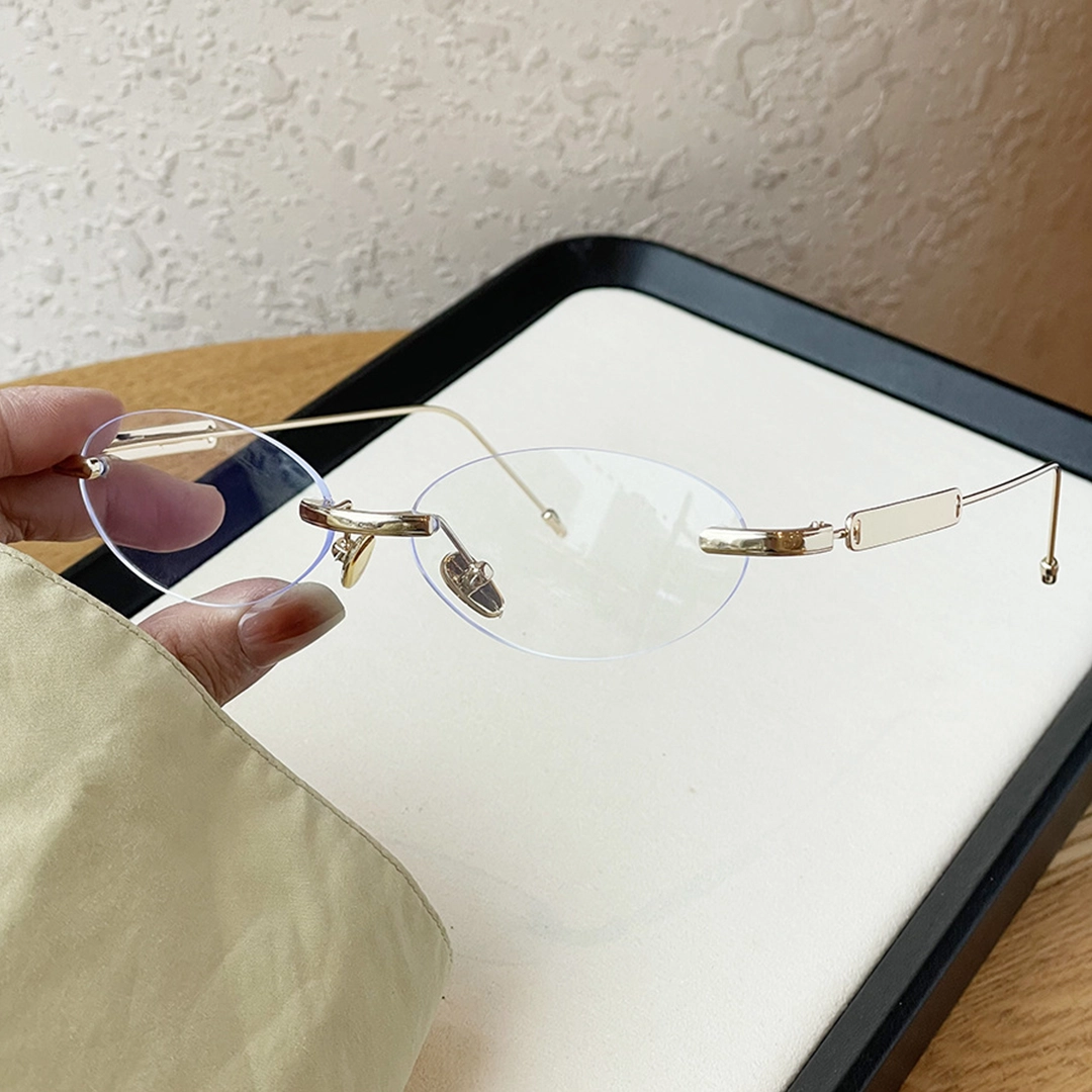 Angle view of Echo oval metal eyeglasses OM0282512 in gold