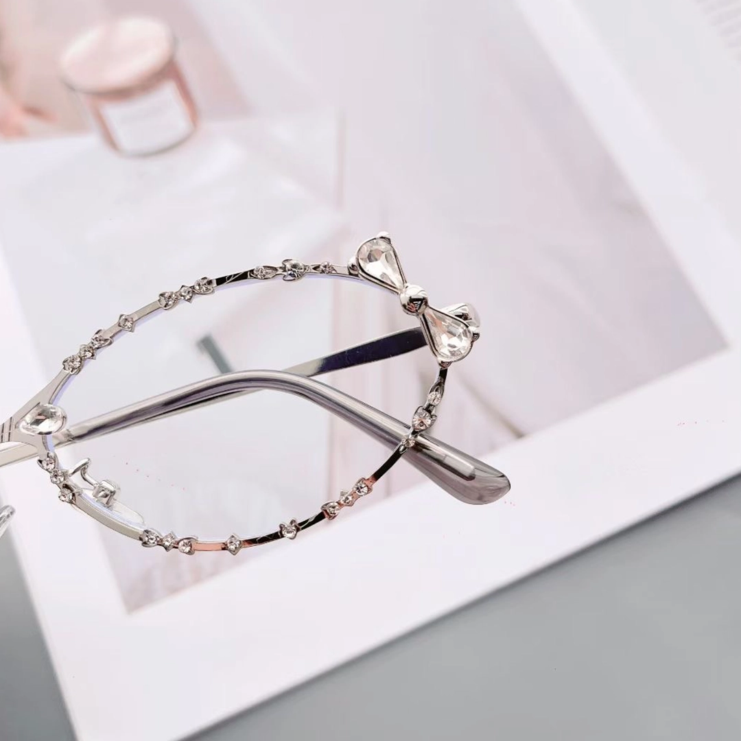 Scene close-up view of Nox y2k oval metal eyeglasses OM0292512 in silver