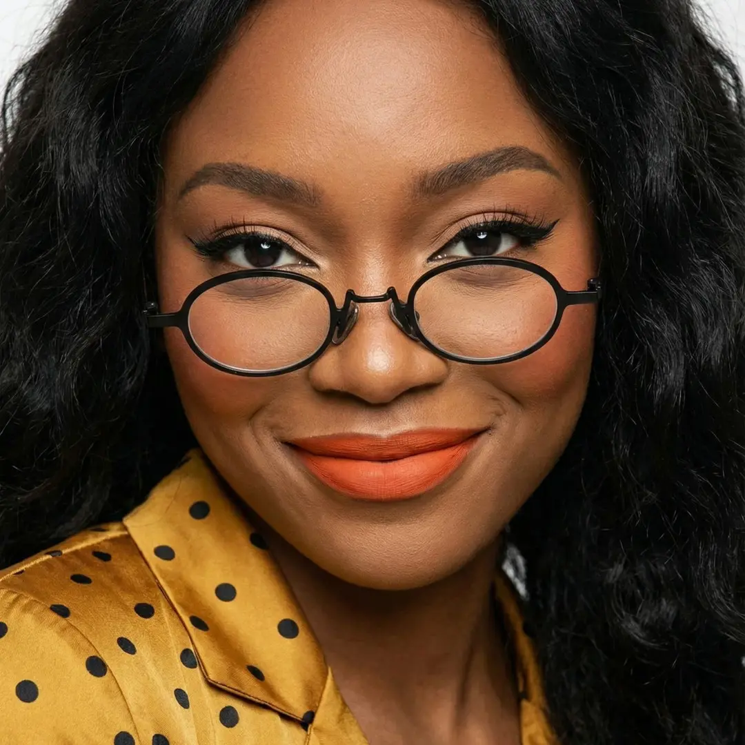 Front view of female wearing vintage black oval eyeglasses, natural smile, OM0592302