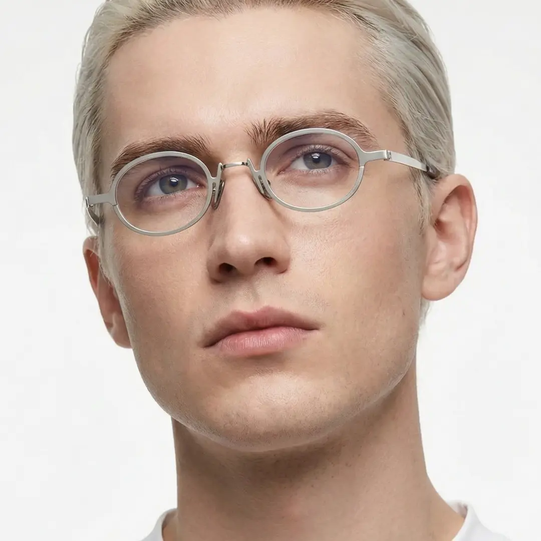Front view of male wearing vintage silver oval eyeglasses, calm expression, OM0592302