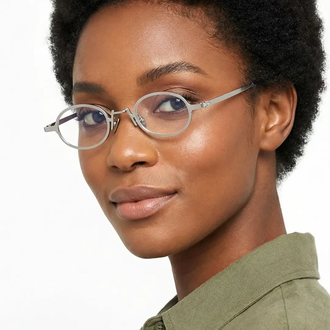 Over-the-shoulder view of female wearing vintage silver oval eyeglasses, natural smile, OM0592302