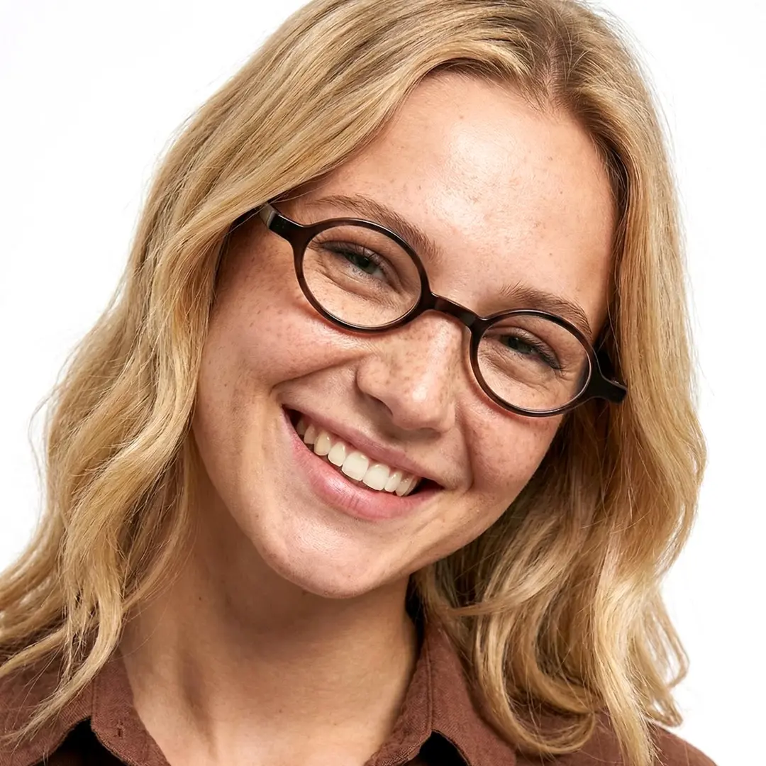 Front view of female wearing grey oval eyeglasses, smiling, OP0142307