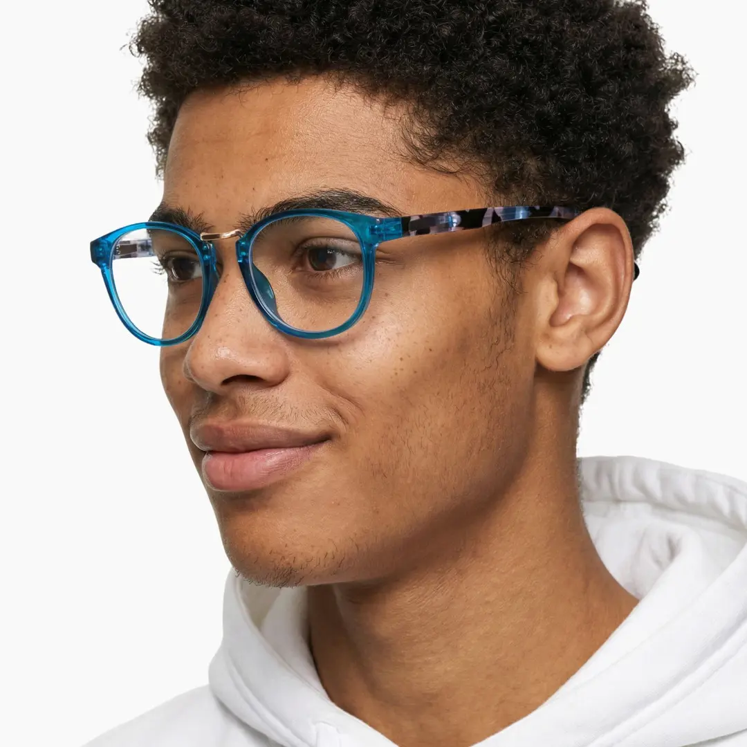 Profile view of male wearing blue oval eyeglasses, neutral expression, OP0222311