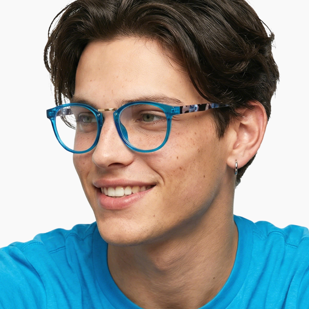 Three-quarter view of male wearing colorful blue oval eyeglasses, smiling, OP0222311