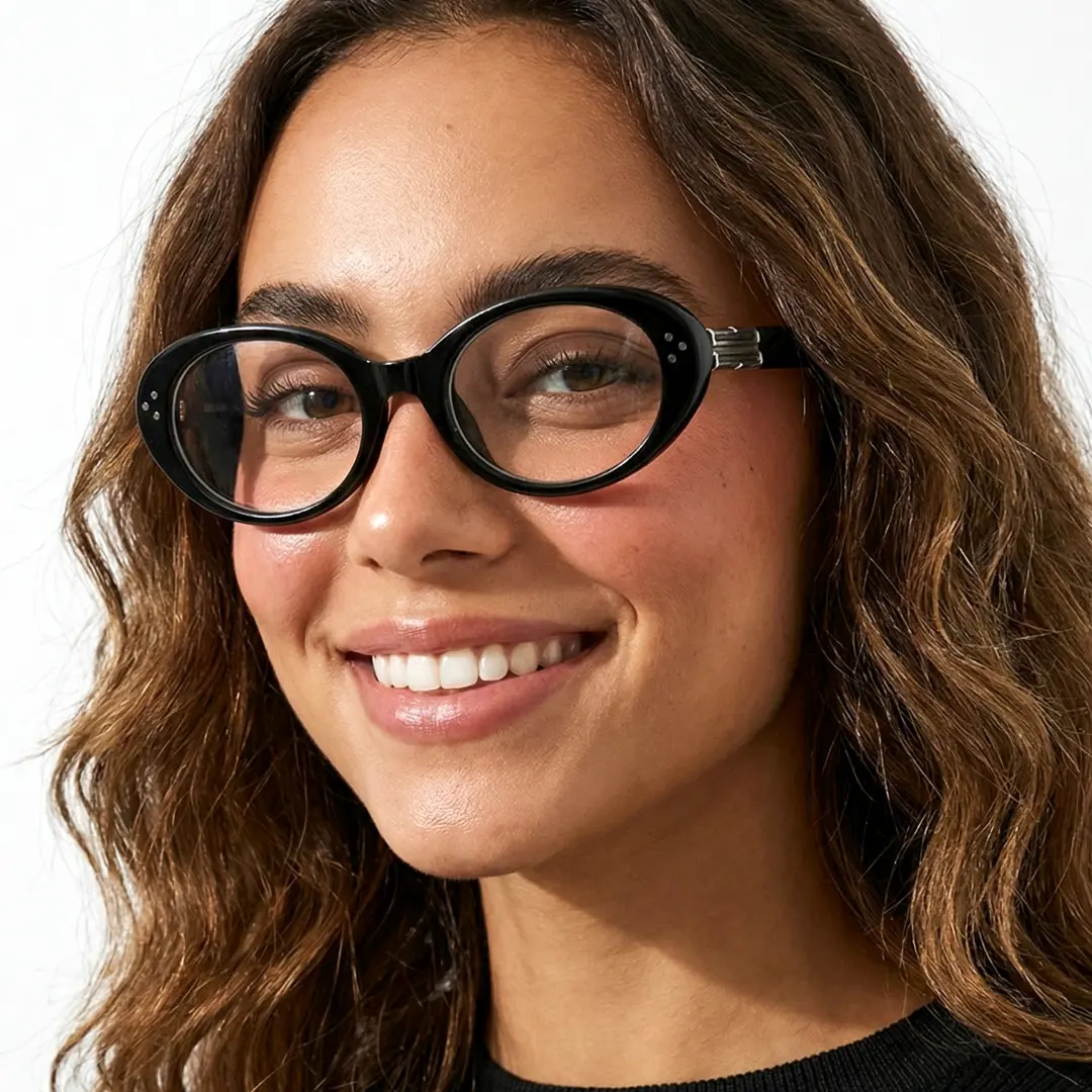 Slightly angled view of female wearing y2k black oval eyeglasses, smiling, OR0022506