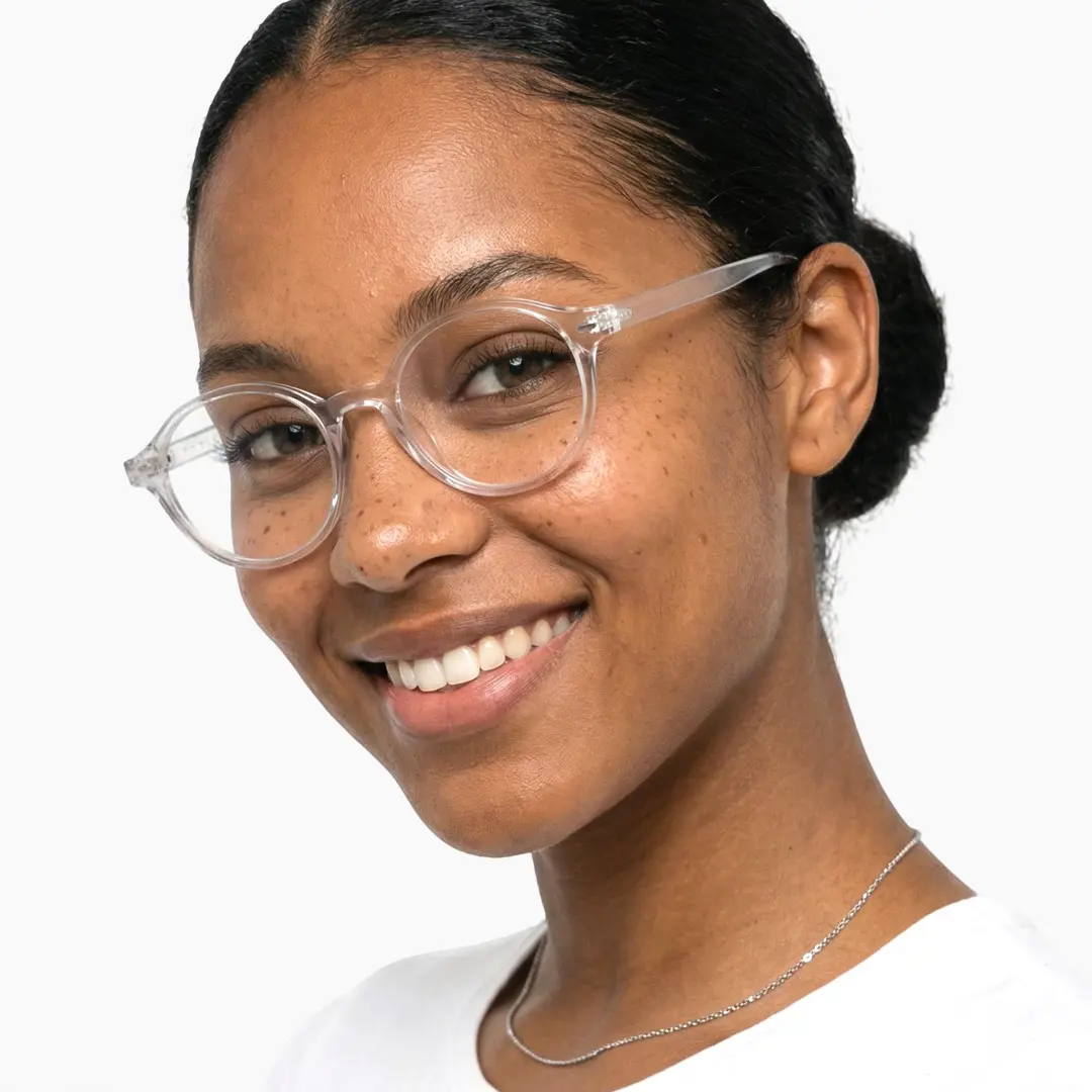 Three-quarter view of female wearing vintage clear oval eyeglasses, natural smile, OR0082406