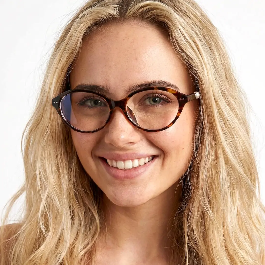 Front view of female wearing y2k tortoise oval eyeglasses, smiling, OR0192509
