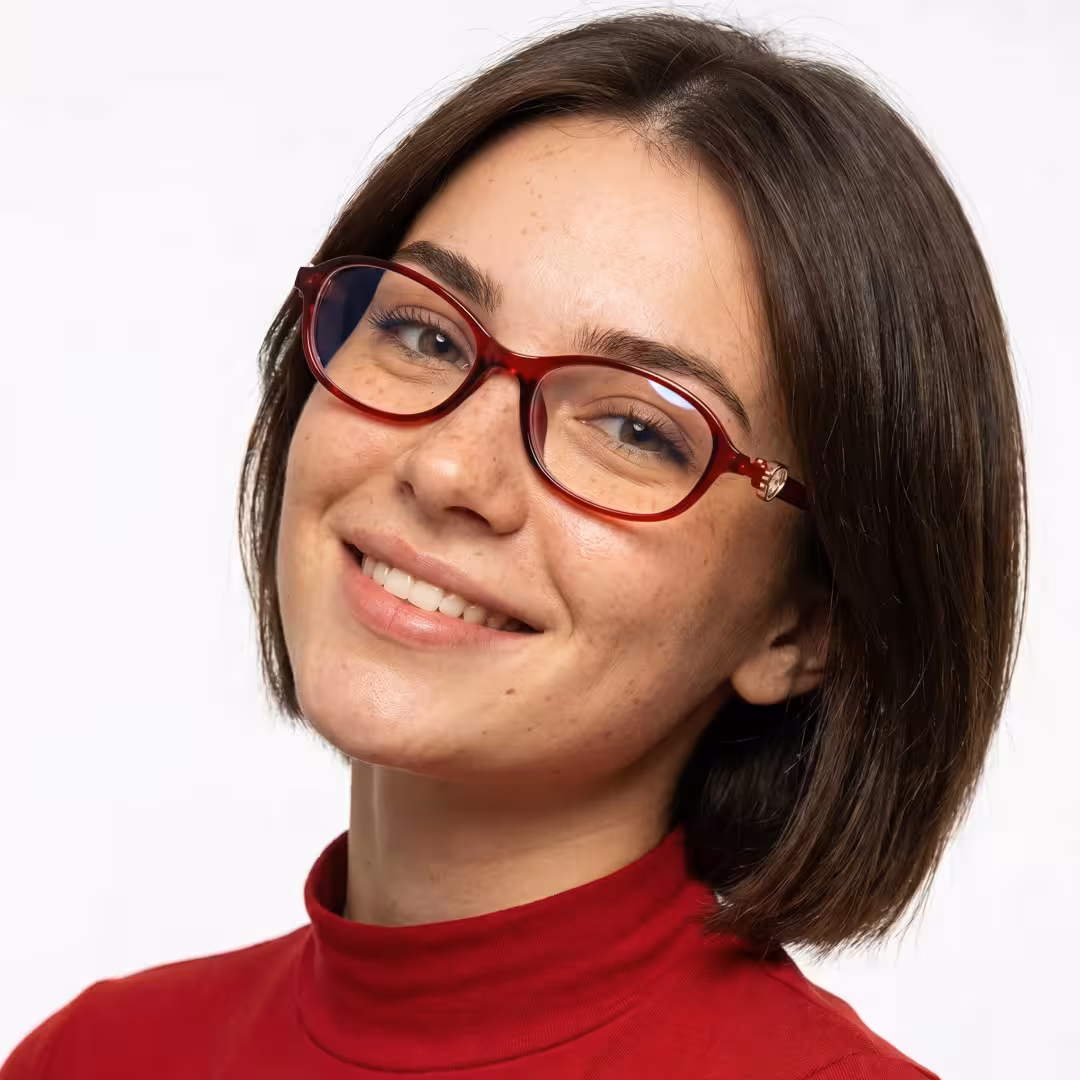 Three-quarter view of female wearing y2k red oval eyeglasses, smiling, OR0212411
