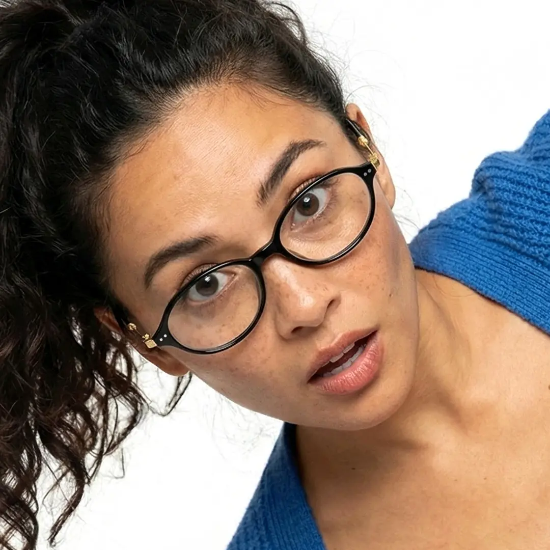Slightly angled view of female wearing y2k black oval eyeglasses, surprise expression, OR0272410