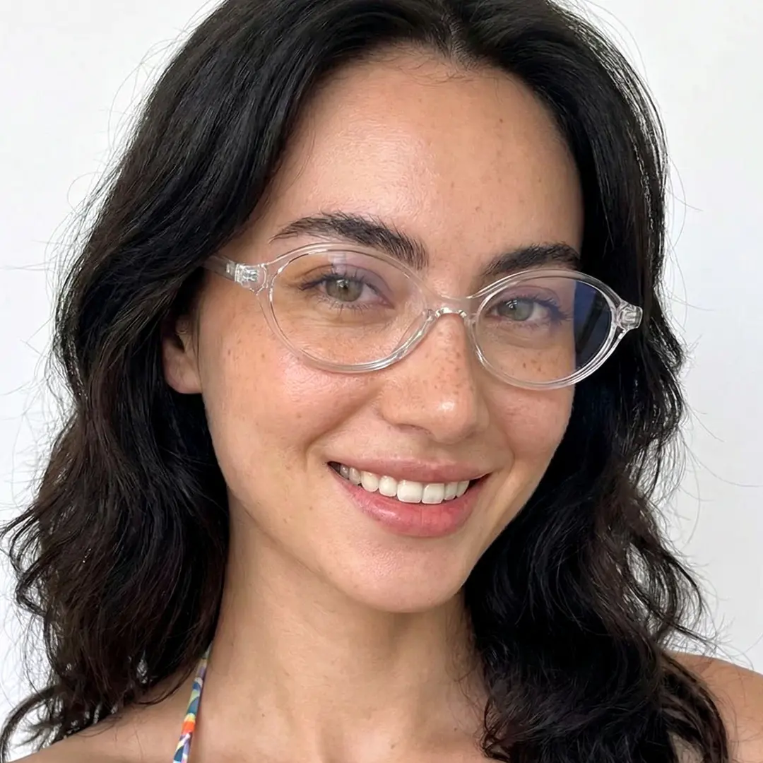 Front view of female wearing y2k clear oval eyeglasses, smiling, OR0312402