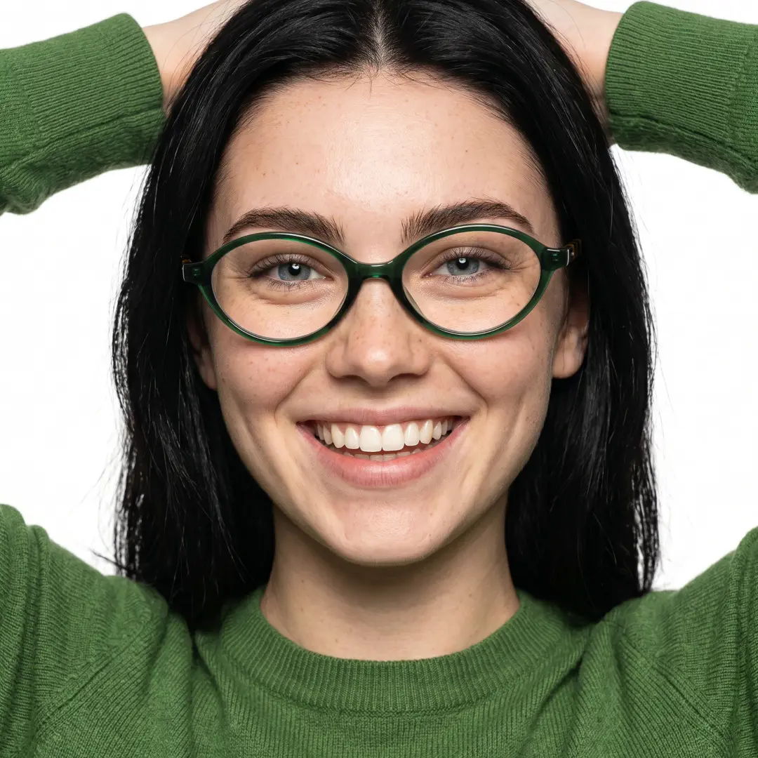 Front view of female wearing green oval eyeglasses, hand resting on forehead, smiling, FS-OR0312402