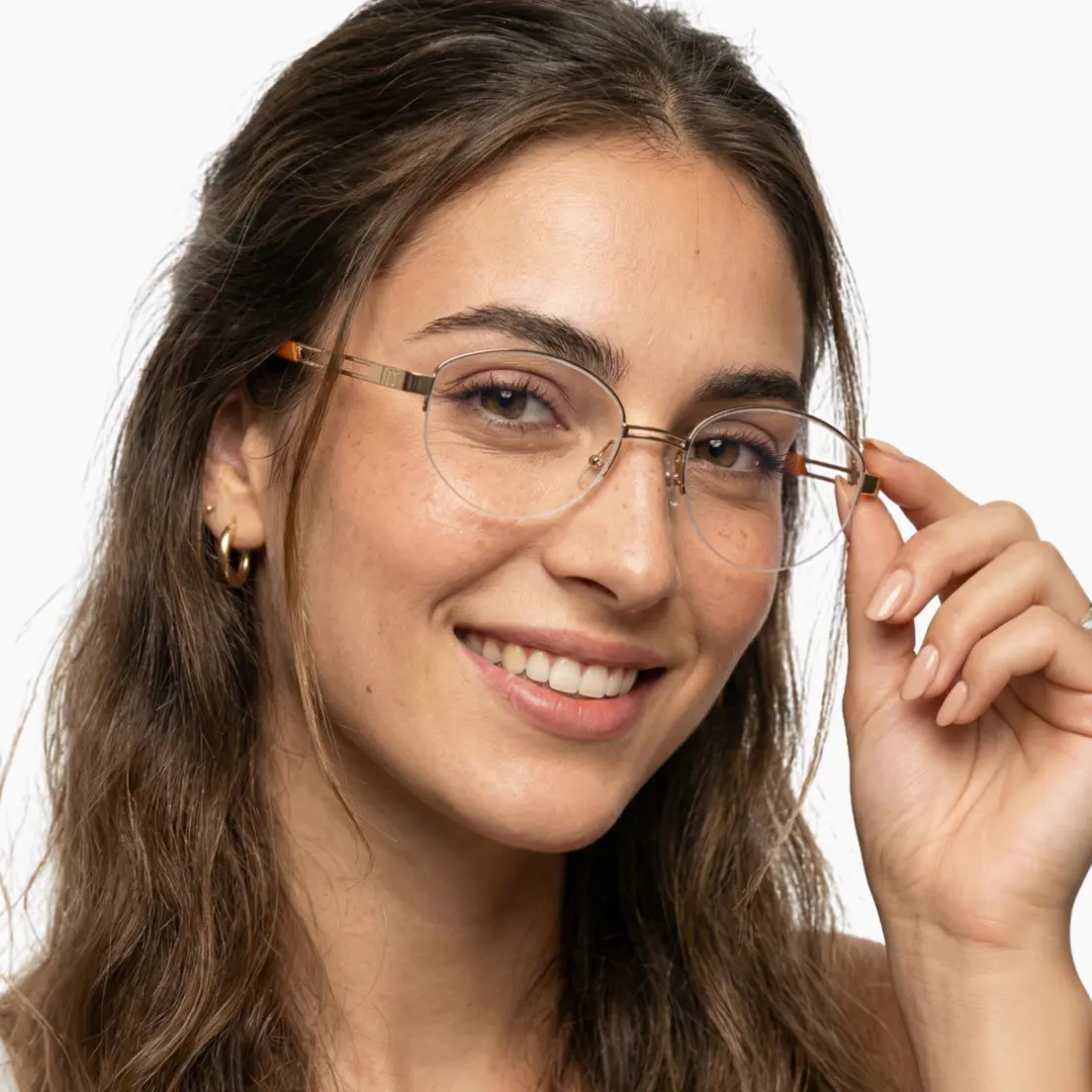 Front view of female wearing y2k gold oval eyeglasses, touching frame, smiling, OT0022501