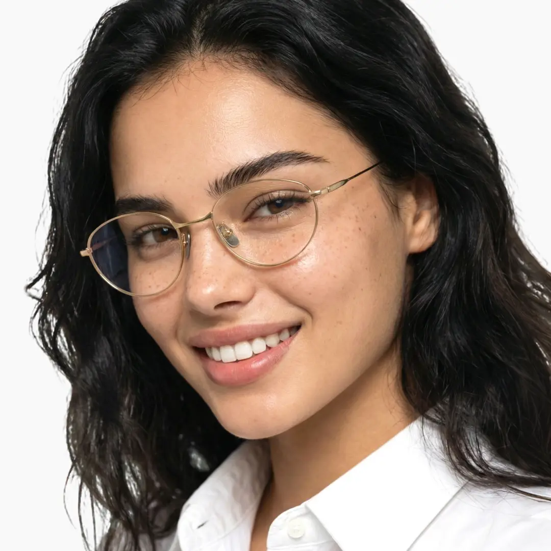 Three-quarter view of female wearing gold oval eyeglasses, natural smile, OT0072501