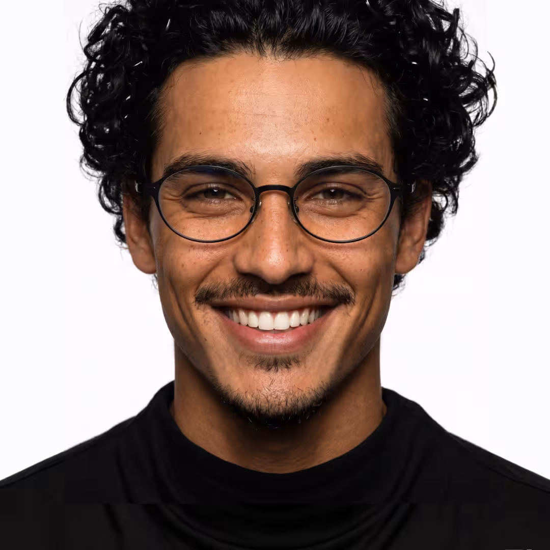 Front view of male wearing y2k black oval eyeglasses, smiling, OT0132412