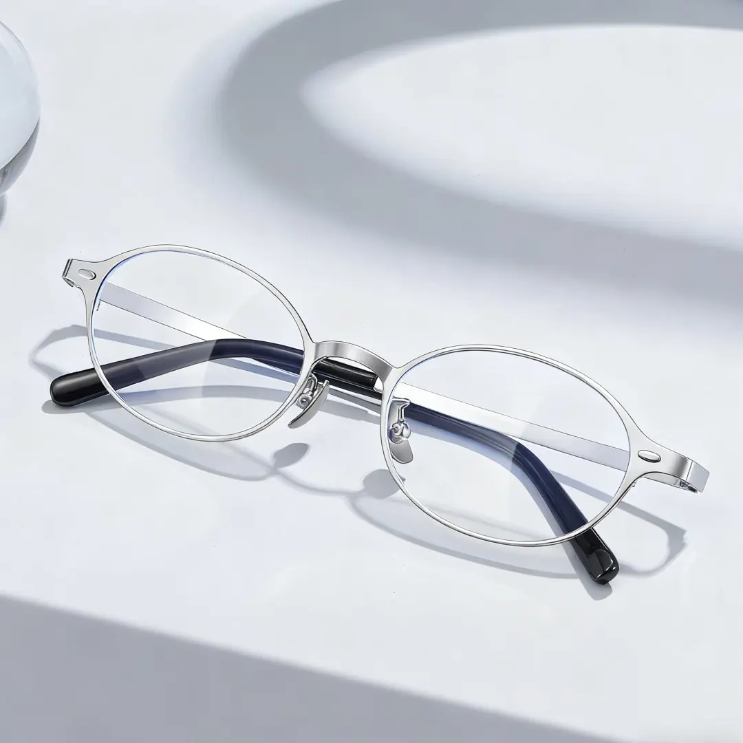 Scene close-up view of Tompkin y2k oval titanium eyeglasses OT0132412 in silver
