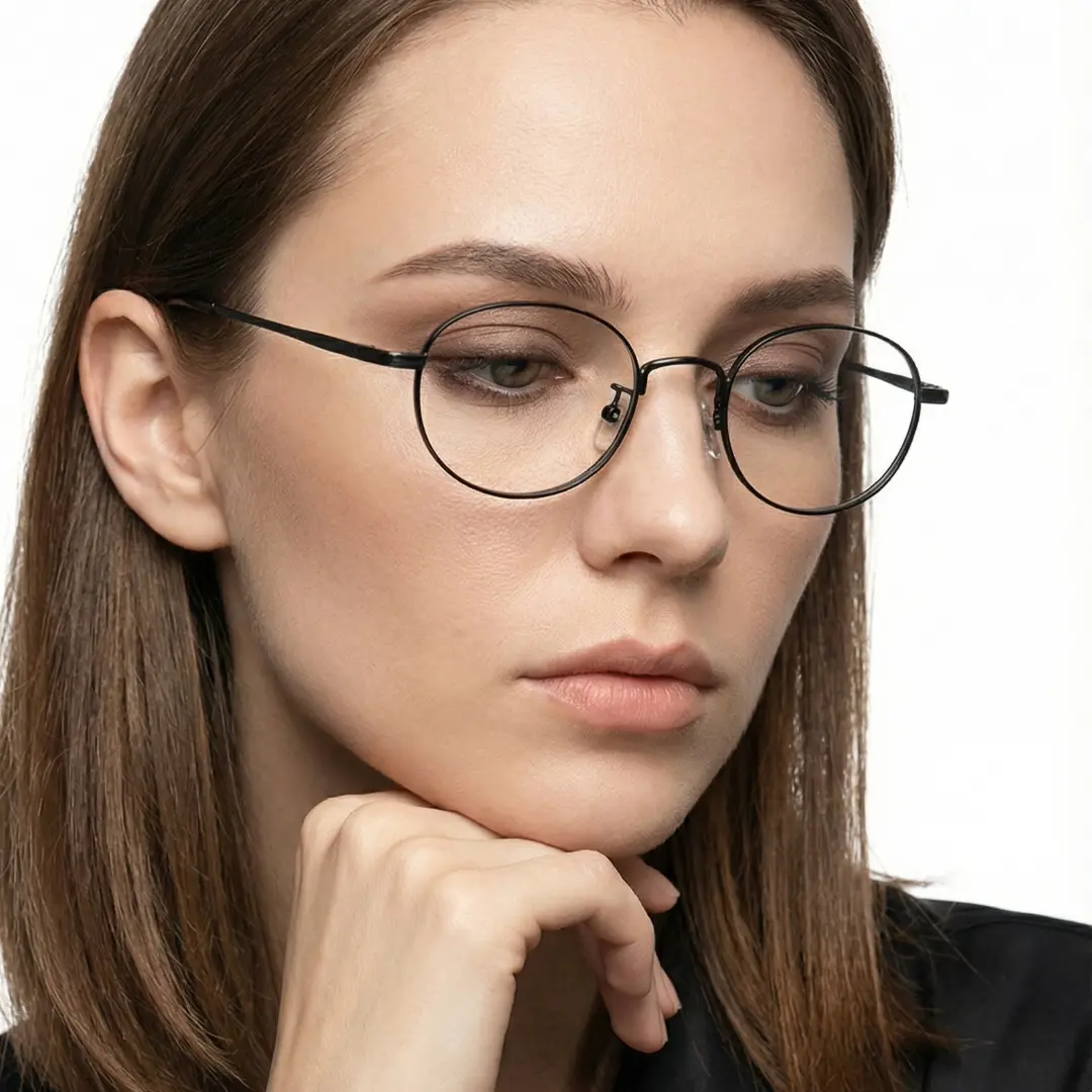 Profile view of female wearing black oval eyeglasses, resting chin on hand, neutral expression, OT0282502