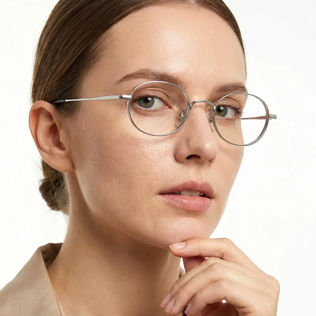 Profile view of female wearing silver oval eyeglasses, natural expression, OT0282502